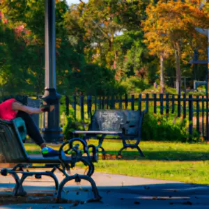 An image showcasing a serene, sunlit park with a fitness enthusiast stretching on a bench, emphasizing the importance of rest days in your fitness regimen